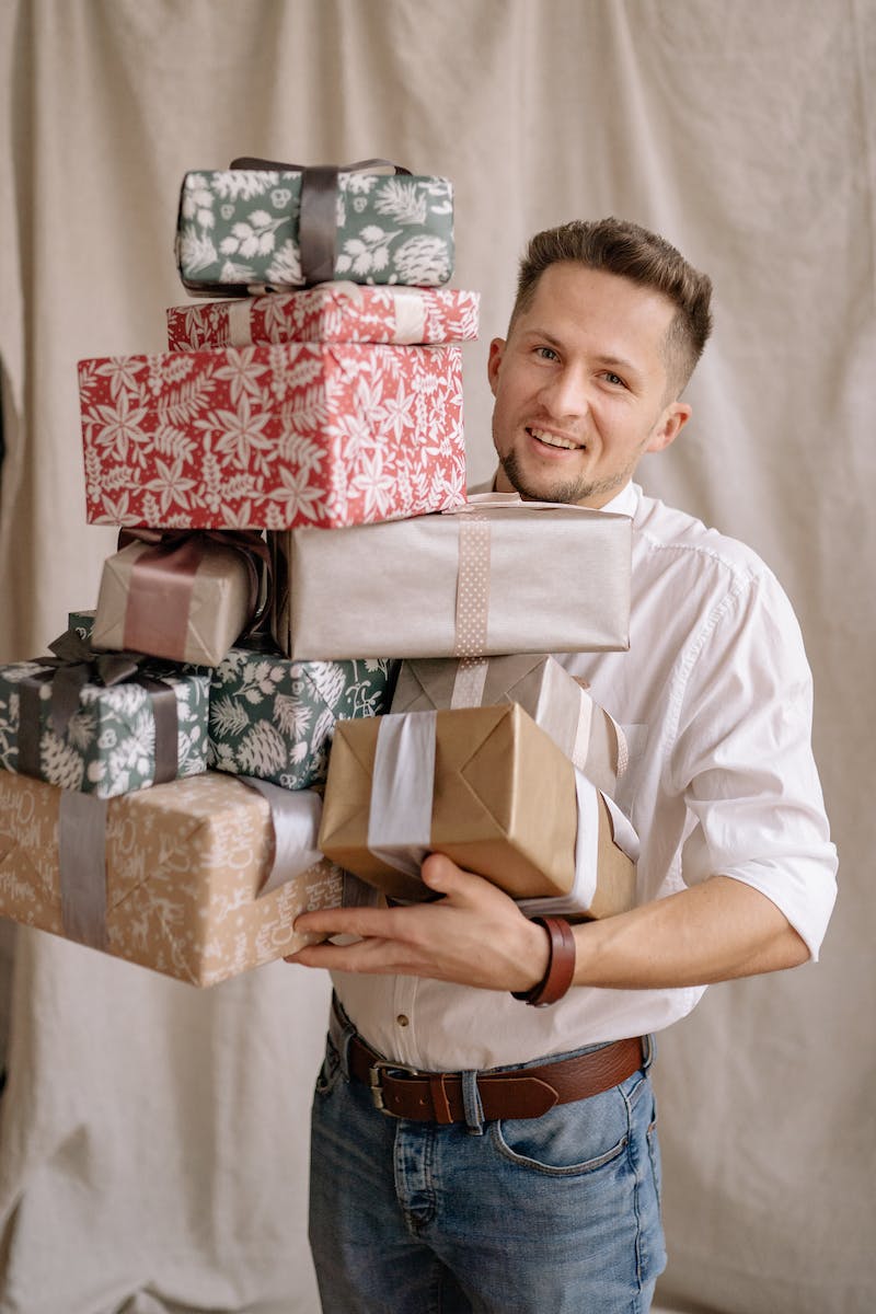 Man in White Button-Up Shirt Carrying Gifts