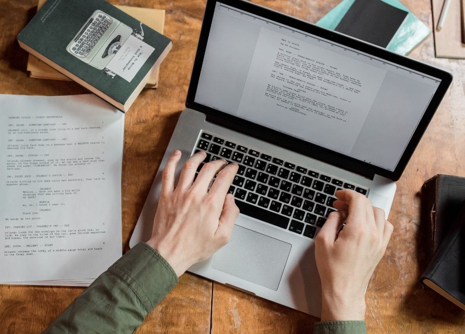 A writer typing on a laptop, brainstorming ideas for their first novel