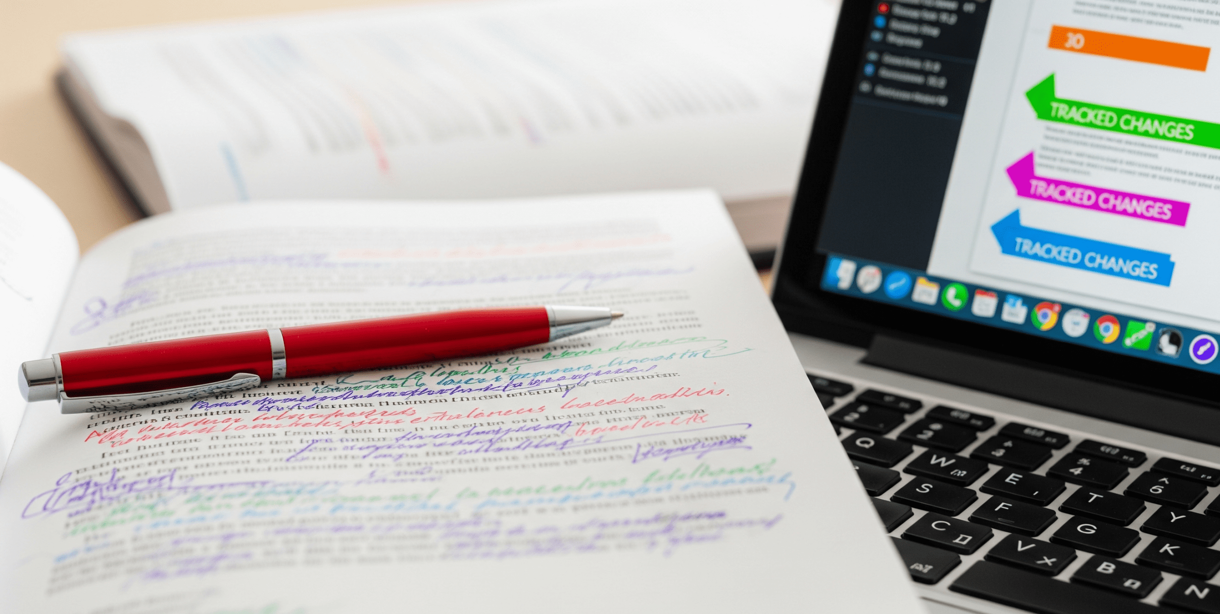 Book editing process in progress with printed manuscript and editing notes.