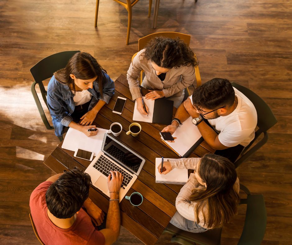 Writers talking and sharing ideas in a welcoming environment, symbolizing what it&rsquo;s like to find a writing community.
