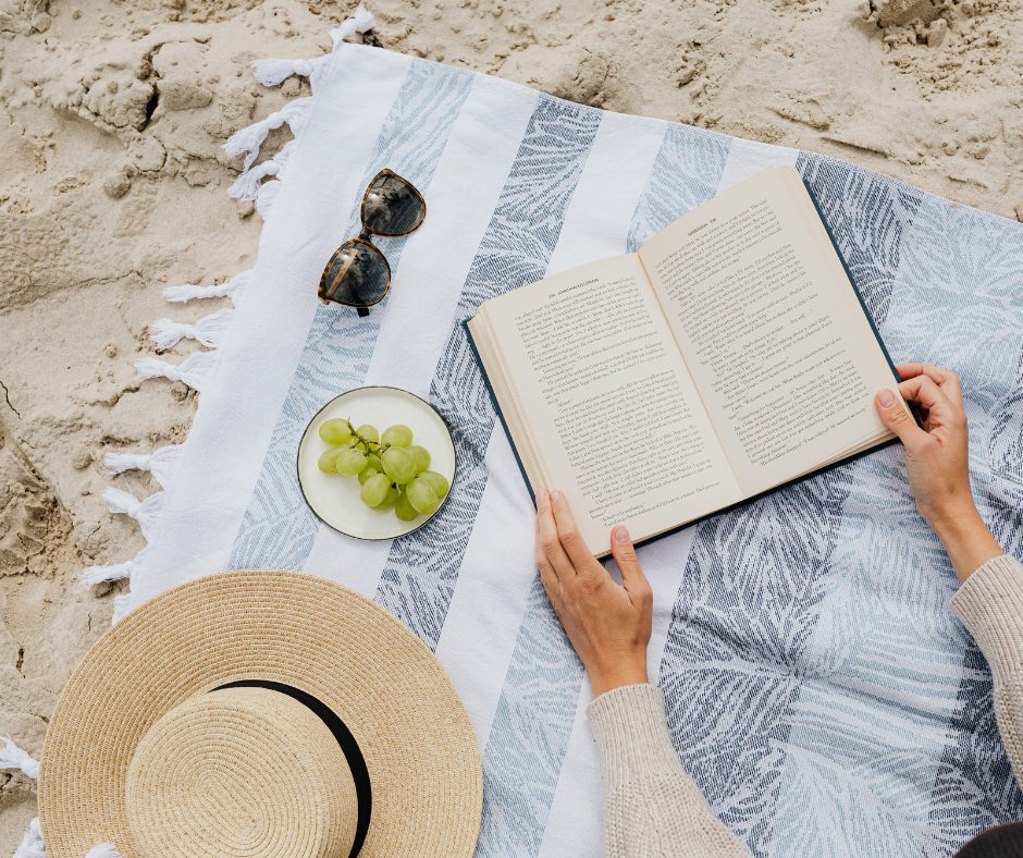August book recommendations with grapes, sunglasses, and an open book